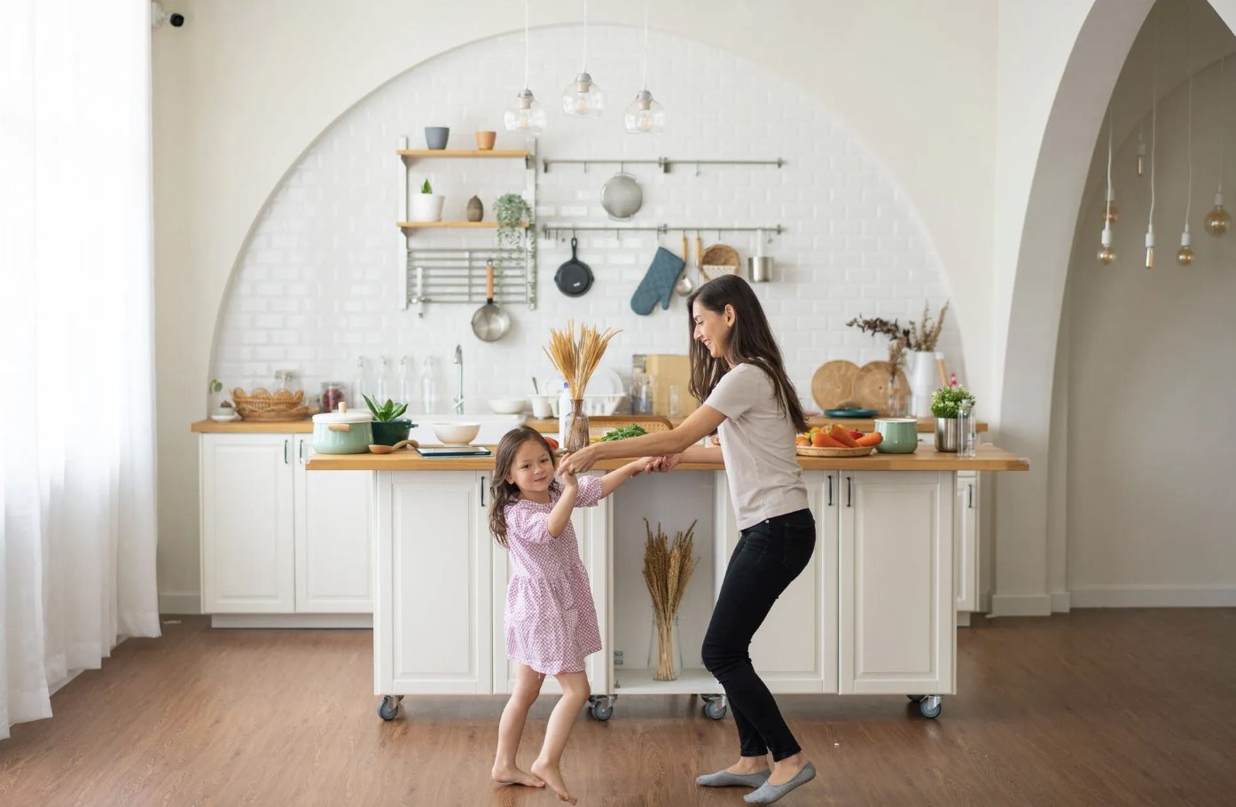 Mother and daughter together in a bright kitchen